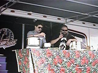 Biker Billy on the Budweiser truck stage with index finger raised.